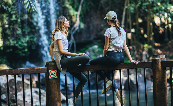 Mount Tamborine women sitting on railing at lookout